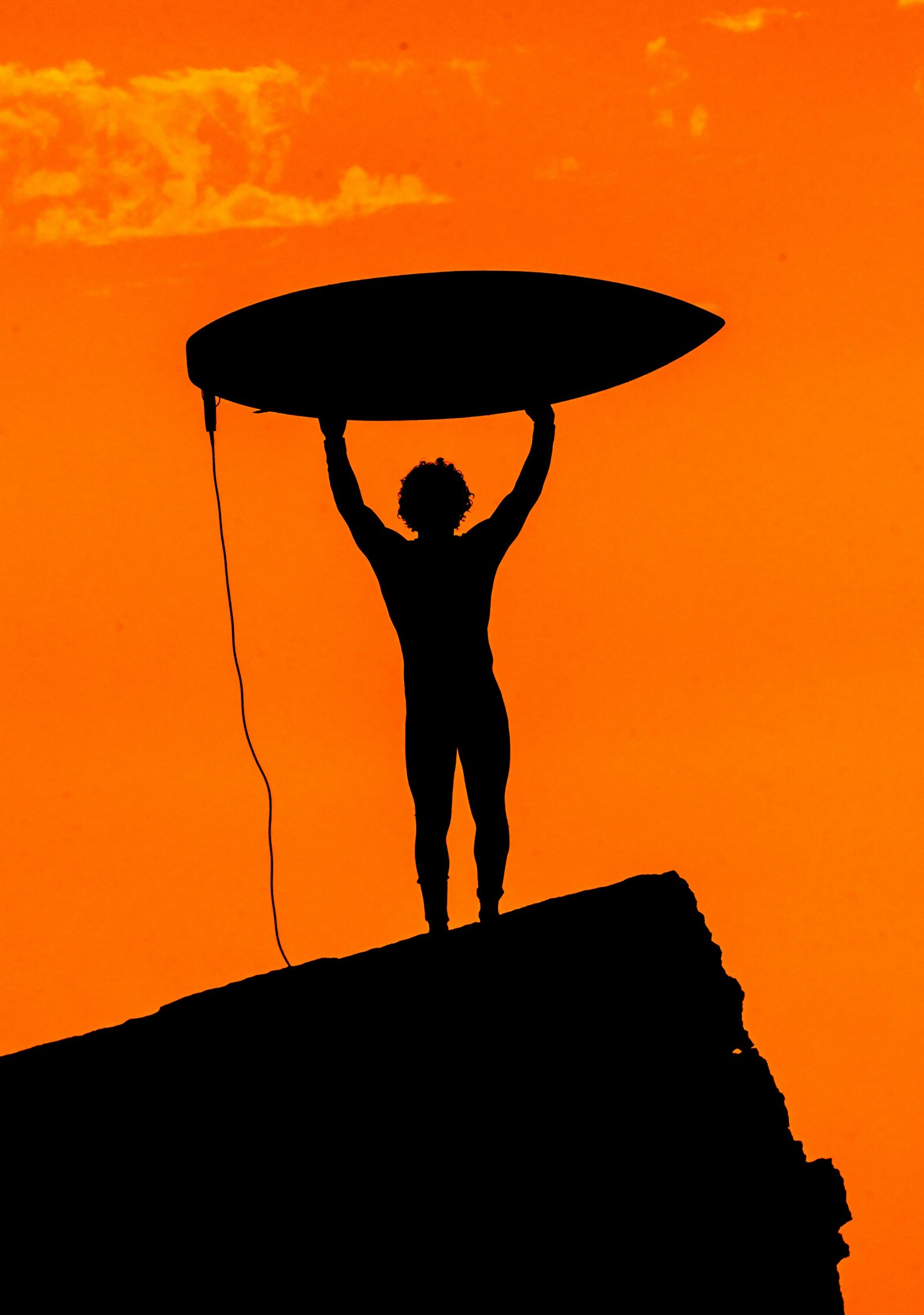 Surfer silhouette at sunset on Agadir coast